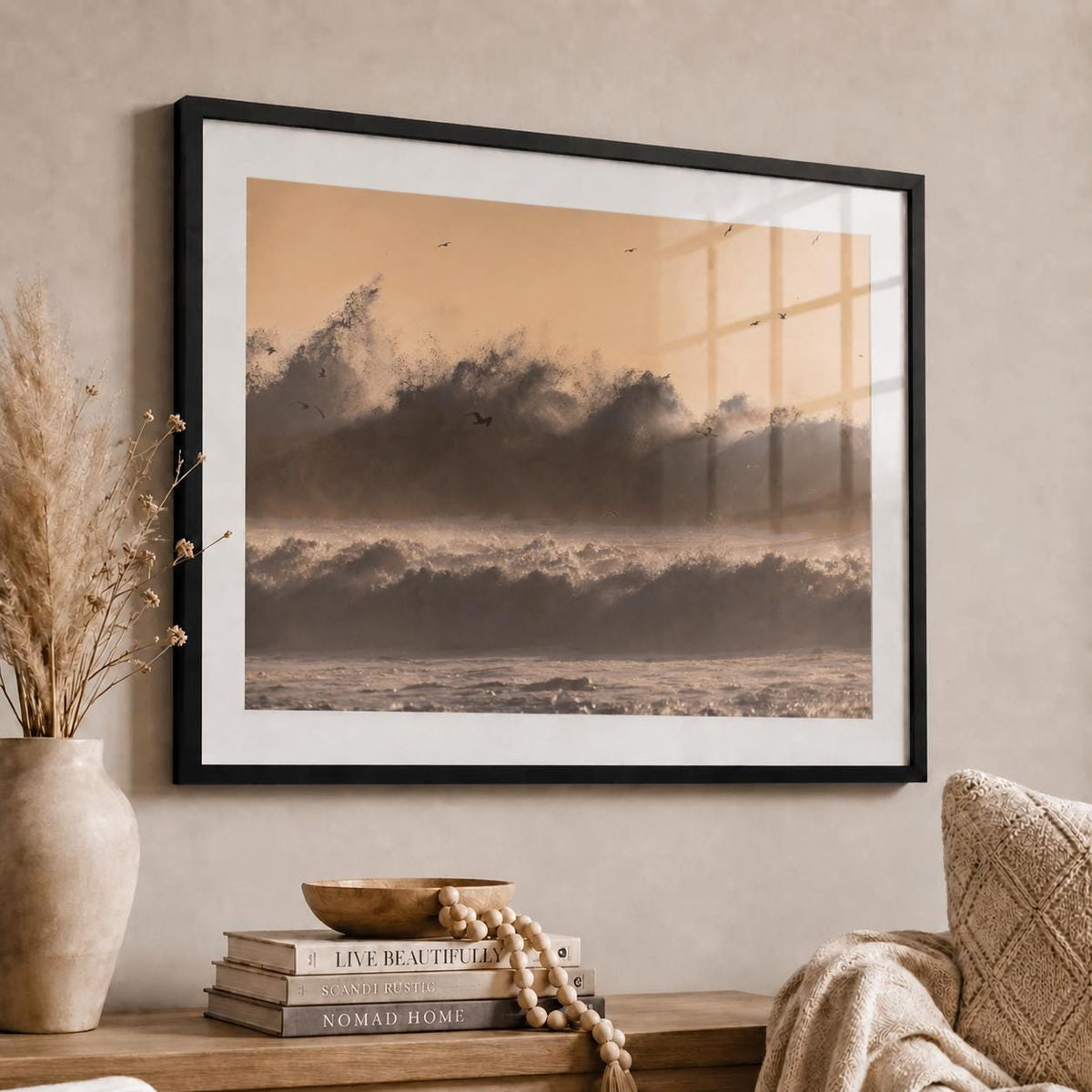 May include: A framed landscape wall art print featuring a monochromatic sepia-toned ocean scene with crashing waves and birds in flight against a soft light sky, displayed in a thin black frame with a white mat border.