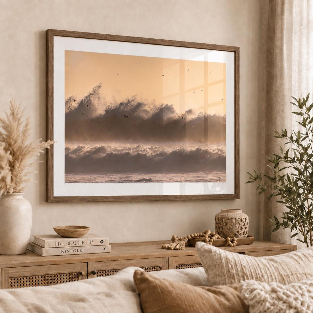 Crashing ocean wave photography displayed in an Oak Vintage Flair frame with a white mat and glossy acrylic glazing, showing a clear window reflection in a warm neutral room.