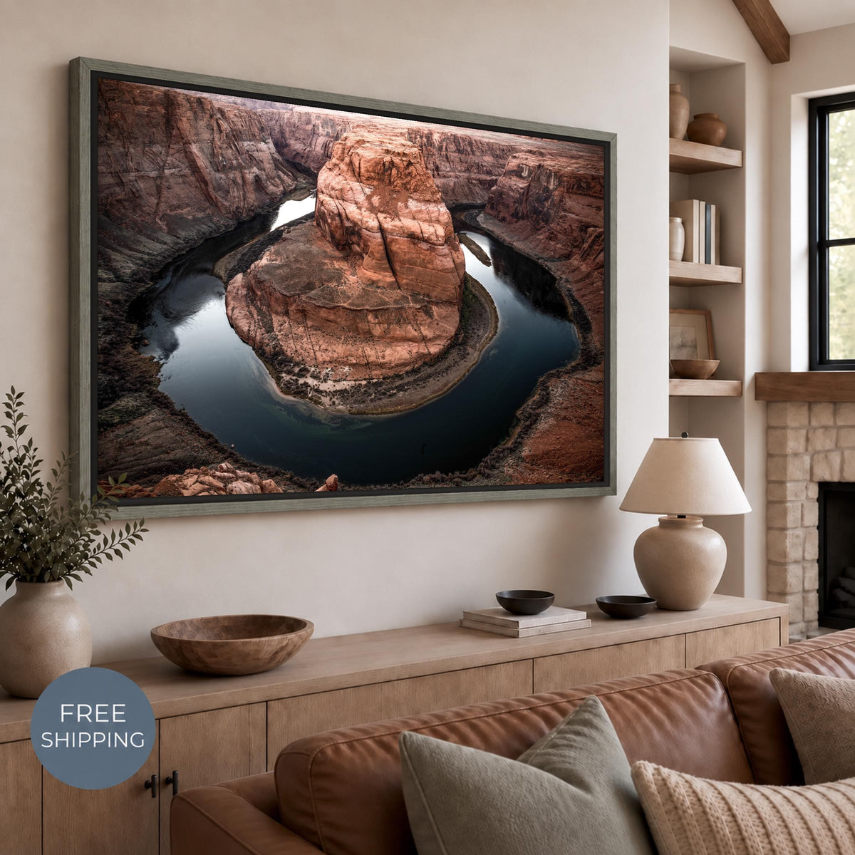 Horseshoe Bend canvas in an Oak Vintage Flair floating frame with a weathered gray-green wood finish. A dark gap separates the canvas from the frame in a warm neutral living room. Free Shipping badge at lower left.