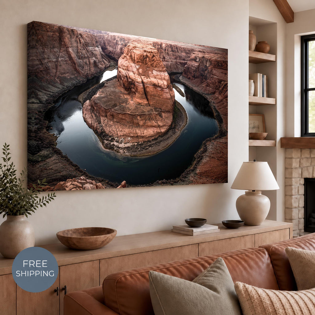 Unframed stretched canvas featuring Horseshoe Bend, with the photograph continuing around the visible canvas edge. Displayed above a wooden sideboard beside pottery and a lamp in a neutral room. Free Shipping badge at lower left.