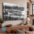 Unframed stretched canvas of a black and white forest, with fog drifting between evergreen trees. The wrapped edge is visible in a room mockup above a wooden console. A badge reads Free Shipping.